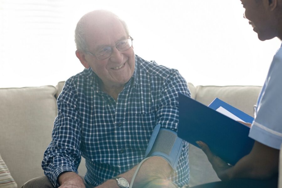 Elderly patient getting his blood pressure checked